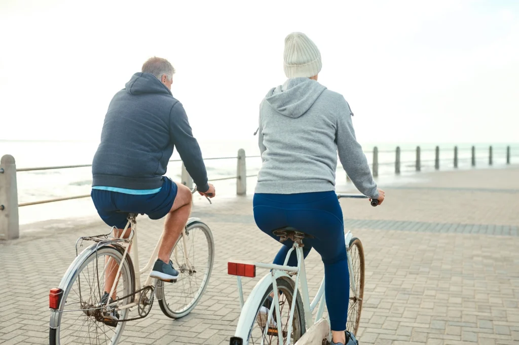 Couple riding bikes, OHF wellness exercise