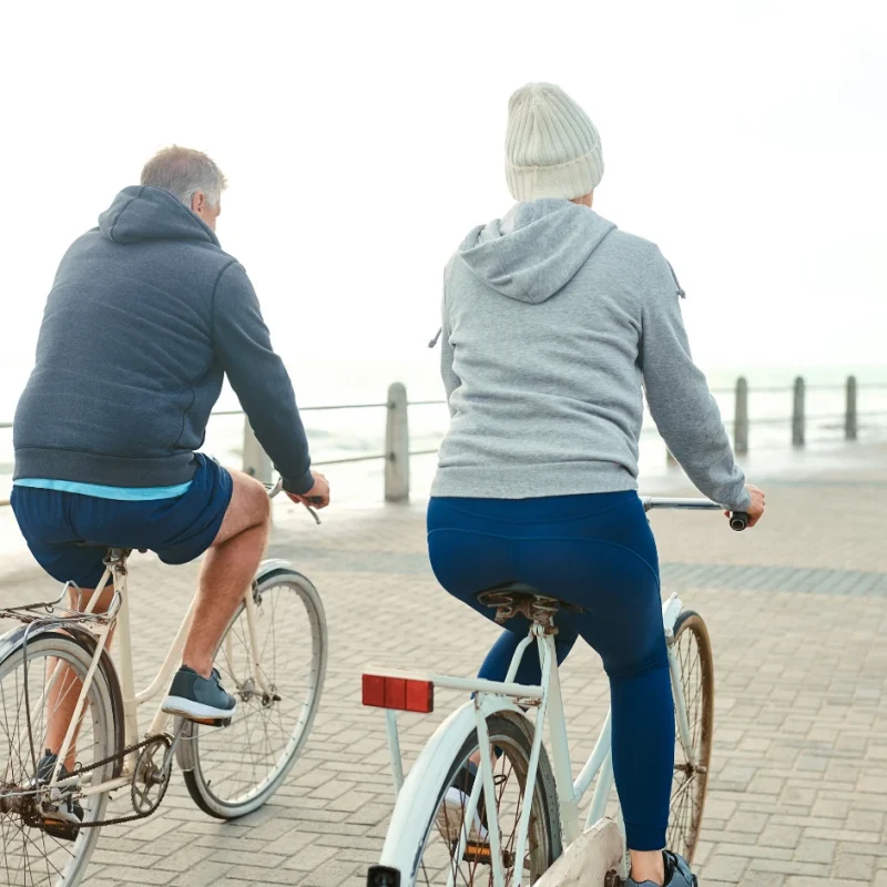 Couple riding bikes, OHF wellness exercise