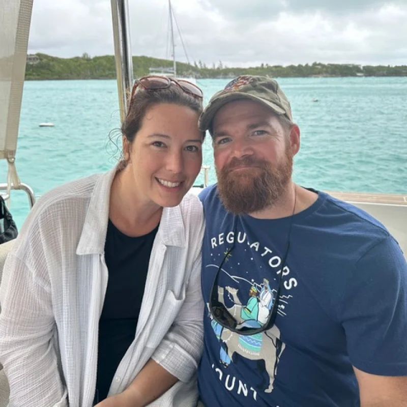 Happy couple on a boat, enjoying a day out, showcasing support for military families and veterans.